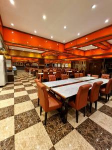 a dining room with a ping pong table and chairs at Grand Parazo Hotel Suvarnbhumi Airport in Bang Bo