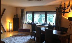 a dining room with a table and chairs and a window at Ferienhaus mit Pool zum Träumen und Entspannen für alle Sinne in Bad Schmiedeberg