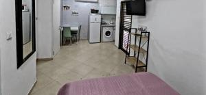 a room with a kitchen with a table and a microwave at 1351 דירת סטודיו עם מרפסת מול הים in Bat Yam