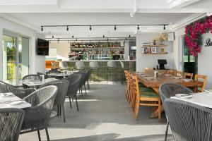 a restaurant with tables and chairs and a bar at Point Break Luxury Apartments in Cape Town