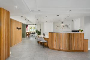 an office lobby with a wooden counter and chairs at Point Break Luxury Apartments in Cape Town +164 photos