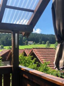 a view from the balcony of a house with a roof at Yimi Ferienwohnung in Grafenwiesen