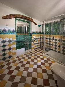 a bathroom with a checkered floor and a shower at Villa Smeralda in Olbia