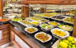 a buffet line with many different dishes of food at The Conforium Hotel İstanbul in Istanbul