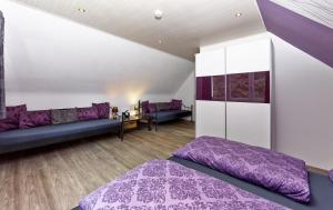 a bedroom with purple and white walls and purple beds at Kühne's 4 Sterne Komfort-Apartments in Braunlage