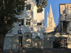 un edificio con un letrero de estacionamiento y una catedral en Duplex vue sur tour Appartement Remparts 3, en La Rochelle