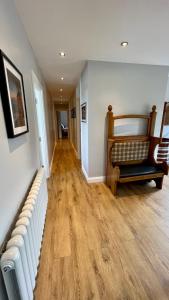 a living room with a couch and wood floors at McCareys Loanen Holiday Home in Larne