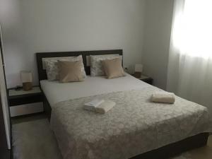 Postel nebo postele na pokoji v ubytování Apartmani Ruzmarin
