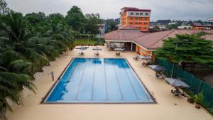 an overhead view of a swimming pool at a hotel at Heliconia Park Port Harcourt Hotel and Suites in Port Harcourt
