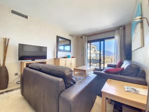 A television and/or entertainment centre at Lovely apartment with pool & sea views - Marina Del Castillo 2129