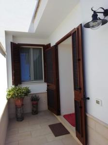 a room with an open door and a window at La Casetta 22 in Andrano
