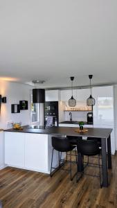 a kitchen with a table and chairs in a room at Hausboot Wangermeerblick (Floating Home) in Wangerland