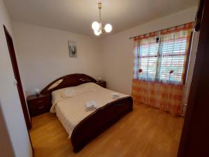 a bedroom with a large bed and a window at Apartment Dominik in Smokvica