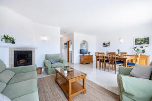 a living room with a couch and chairs and a table at Townhouse da Amarela in Budens