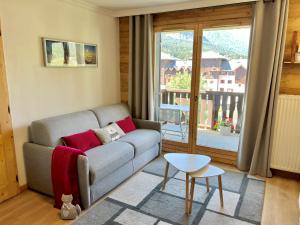 a living room with a couch and a large window at Mont Blanc 43, vue Mont Blanc , balcon, parking in Chamonix