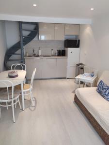 een keuken en een woonkamer met een tafel en een bank bij Les pavés bleus - Cœur de Deauville in Deauville