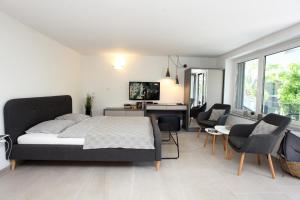 a bedroom with a bed and a desk and chairs at Modern Apartment Parenzana IZMA in Portorož