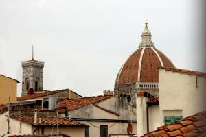 a view of a building with a clock tower and roofs at La Torre di Anna in Florence