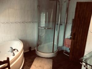 Tudor House - Double Room - Shared Bathroom في Goffs Oak: حمام مع دش وحوض استحمام ومغسلة