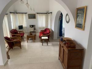 a living room with chairs and a couch and a table at Villa Zeytin - Private Pool Villa in Vasilia