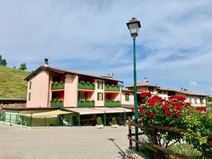 a building with a street light in front of it at Hotel Edelweiss in San Zeno di Montagna