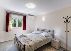 a bedroom with a bed with two towels on it at Fragiato Apartment in Lefkada Town