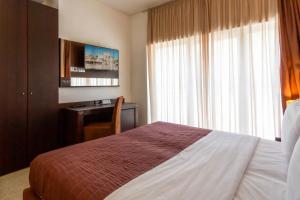 Postel nebo postele na pokoji v ubytování Hotel Petit Palais