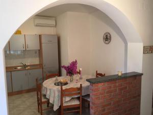 a kitchen with a dining room table with a tableablish at Apartments Tamara in Orebić