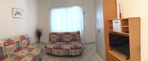 a living room with two couches and a window at Apartments Tamara in Orebić