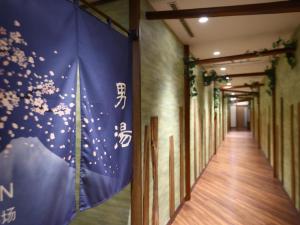 a corridor of a building with a flag on the wall at Dormy Inn Express Fujisan Gotemba in Gotemba