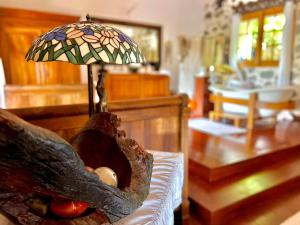 a lamp sitting on a couch in a living room at Les Grands Monts in Saint-Joseph