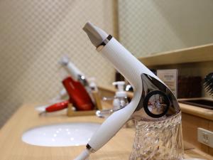 a toothbrush in a glass on a sink at Dormy Inn Express Fujisan Gotemba in Gotemba