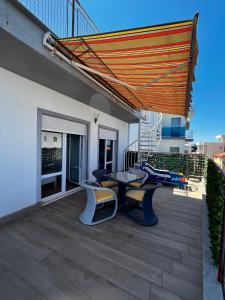 eine Terrasse mit einem Tisch und Stühlen auf dem Balkon in der Unterkunft Apartments Apartmani Bojana in Utjeha
