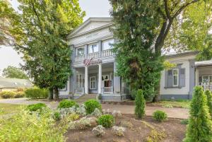 a white house with trees and flowers in front of it at Valensija - Suite for two in nice hotel in Jūrmala