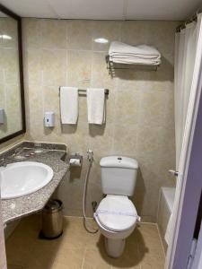 a bathroom with a white toilet and a sink at Retac El Arish in El Arish