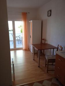 a kitchen with a table and a refrigerator at Apartments Blazenka in Trogir