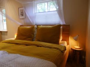 a bed in a bedroom with a window at The Sunbird Inn - with luxurious bathroom in Diessen