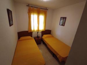 Łóżko lub łóżka w pokoju w obiekcie Apartamento LAIA