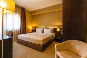 Postel nebo postele na pokoji v ubytování Hotel Petit Palais