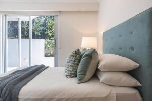 una camera da letto con un letto con una lampada sopra di Stunning Harbourside Home with Panoramic Views a Sydney