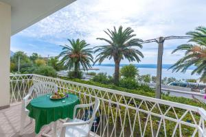 balcón con mesa, sillas y vistas al océano en Apartments Marija, en Duće