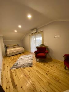 a bedroom with a bed and a wooden floor at Sky Villas Hisar in Trabzon