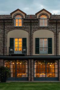 an exterior view of a brick building with windows at Spinerola Hotel in Cascina & Restaurant UvaSpina in Moncalvo