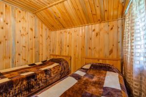 a room with two beds in a wooden cabin at Guesthouse Kvavlo in Kvavlo +30 photos