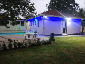 a house with blue lights on the side of it at Munach Guest Lodge in Benoni