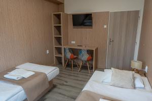 Postel nebo postele na pokoji v ubytování Hotel Garni
