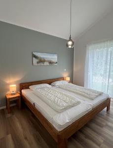 Postel nebo postele na pokoji v ubytování Haus JadeMuschel - behagliches Haus mit Aussicht