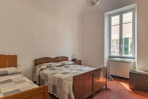 A bed or beds in a room at Rivierarent Casa Iolanda