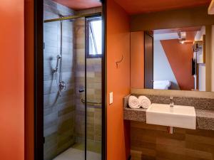 a bathroom with a sink and a shower at Ibis Budget Balneario Camboriu in Balneário Camboriú