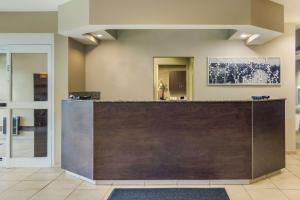 a lobby with a reception desk in a building at Sleep Inn & Suites Steubenville at the University in Steubenville